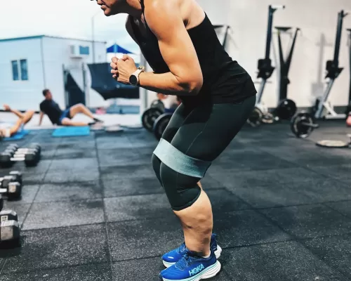 a woman doing her resistance band exercise at a gym