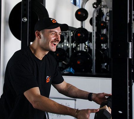 Brad wearing black staff shirt with Physical Fix