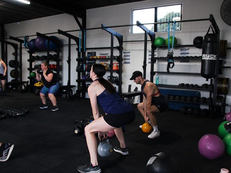 Group session doing lift exercise