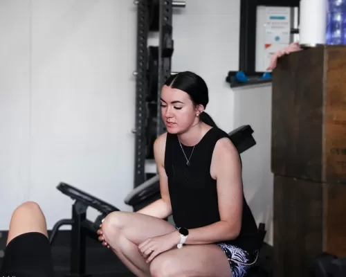 a personal gym trainer guiding her trainee