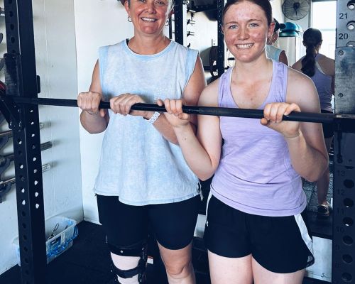 2 girls holding bar equipment